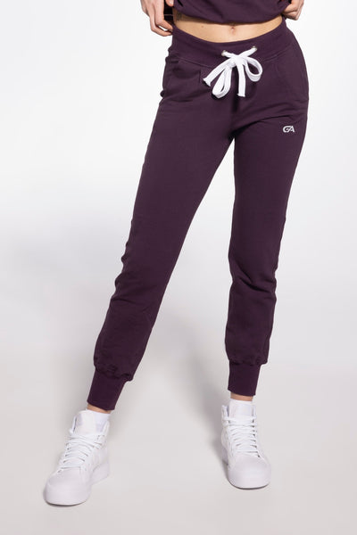 Gatta cotton sweatpants in plum purple, front view with a white drawstring and cuffed hems.