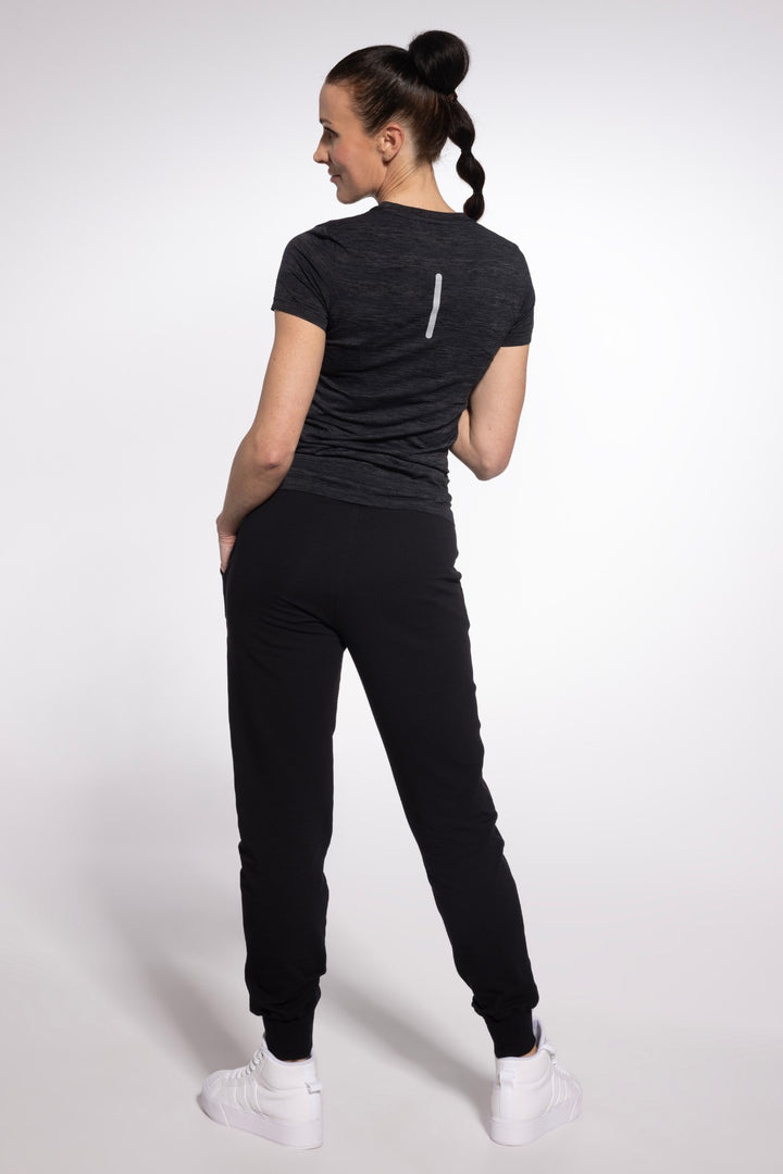 Black training top back view, full length
