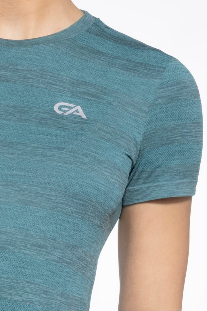 Green women's gym top front close-up, seamless fabric detail
