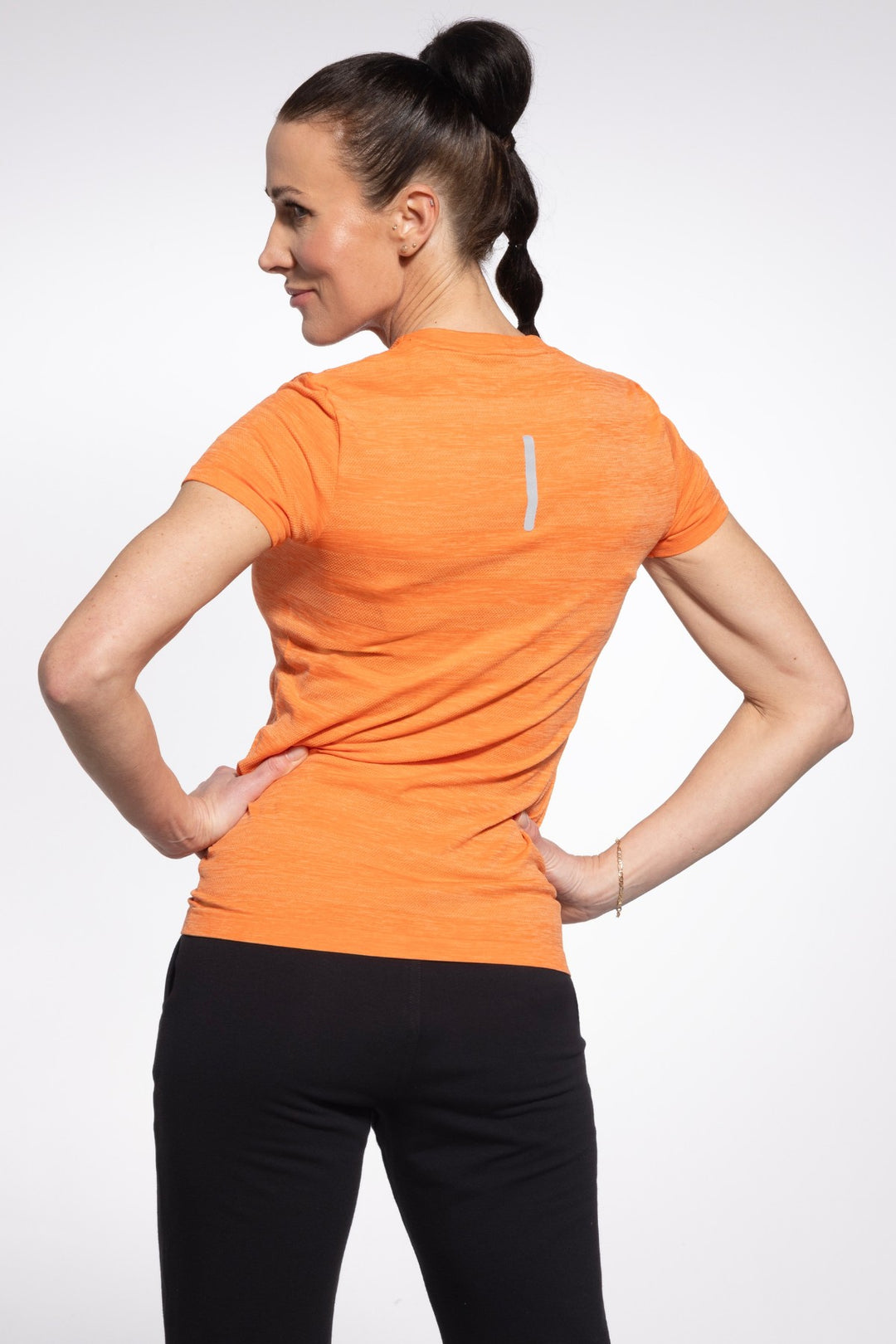 Orange activewear T-shirt back view, full length
