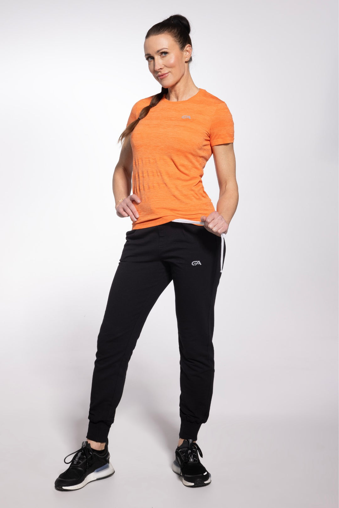 Orange training top front view, full length, alternate angle
